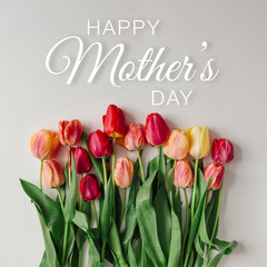 Wall Mural - Happy Mothers day with tulips on white background. Flat lay.