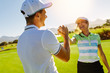 © Jacob Lund - Golfers shaking hands at golf course