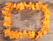 Dutch orange flower necklace on wooden background