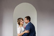 © Wedding photography - Happy couple, bride and groom embracing near wedding arch