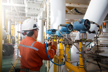 Technician,Instrument technician on the job calibrate or function check pneumatic control valve in process oil and gas platform offshore,technician