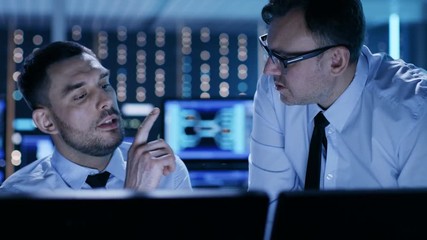 Aufkleber - Two Professional Technicians Discussing Problems Shown on Multiple Monitors in a System Control Center. Shot on RED EPIC-W 8K Helium Cinema Camera.