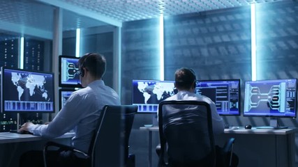 Aufkleber - Panorama Shot of System Control Room with Three Technical Controllers Working at Their Workstations With Multiple Displays. Shot on RED EPIC-W 8K Helium Cinema Camera.