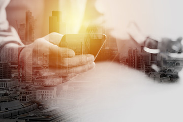 Poster - close up of businessman working with mobile phone and eyeglass on wooden desk in modern office