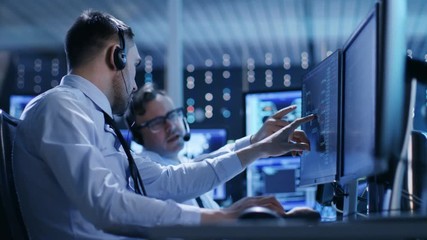 Poster - In the System Control Center Technical Support Team Gives Instructions with the Help of the Headsets. Possible Air Traffic/ Power Plant/ Security Room Theme.
