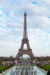 Eiffel tower against cloudy sky