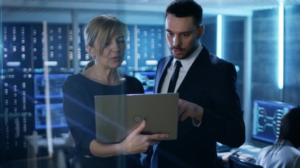 Aufkleber -  In System Control Room Female and Male Top Managers Have Discussion. In the Background Professional Engineers Work. Multiple Displays Show Useful Data. Shot on RED EPIC-W 8K Helium Cinema Camera.