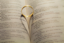 Wedding Rings Casting A Heart Shape On A Book