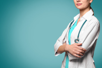 Canvas Print - Beautiful young doctor with stethoscope on grey background, closeup