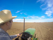 Agriculture. Farmer in the field driving tractor. Cultivating and seeding. Agronomy.
