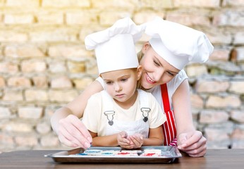 Canvas Print - Woman and child cooking.