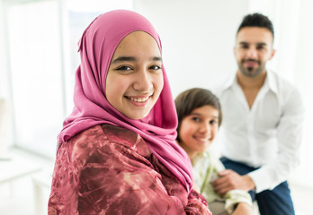 Wall Mural - Happy Arabic Muslim family at modern home having fun and good time together