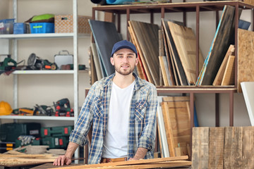 Wall Mural - Handsome young carpenter in workshop