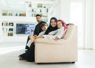 Wall Mural - Muslim Arabian family on sofa at home