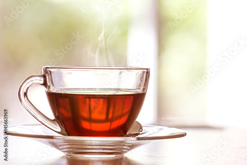 Fotomural Close up warm black tea cup on wooden table in living room , relax with tea tim