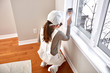 © grinny - Woman painting window trim