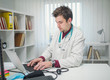 © Dzelat - Doctor working on laptop in his office alone