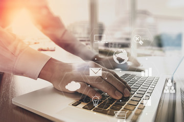 Poster - businessman working with laptop computer on wooden desk in modern office with virtual icons interface