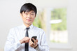 © fotofabrika - Asian businessman talking on mobile cell phone