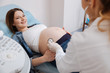 Positive woman getting pregnant belly examination in the hospital