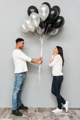 Wall Mural - Man give to woman a lot of balloons.