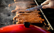 Sausages grilling on hot barbeque