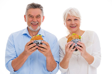 Wall Mural - Senior couple eating hamburgers
