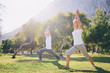 © luengo_ua - Yoga at park. Senior family couple exercising outdoors. Concept of healthy lifestyle.