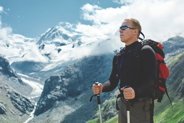 Wall Mural - hiker on the trail in the Apls mountains. Trek near Matterhorn mount. Mountain ridge on the background