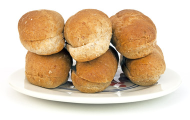 Whole wheat buns on plate. Isolated.