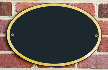 Wall Mural - Empty oval plaque attached to brick wall. Copy space.