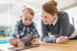 © Igor - mother and toddler son looking at tablet at home