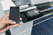 © magneticmcc - Using smart phone with printer to print the document