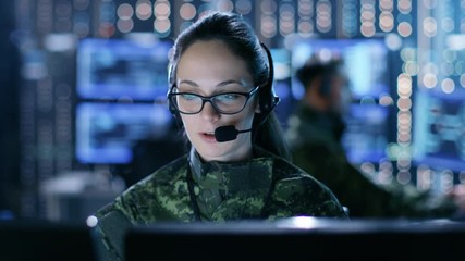 Aufkleber - Female Military Technical Support Professional Gives Instructions into Headset. She's in a Monitoring Room with Other Officers and Many Working Displays. Shot on RED EPIC-W 8K Helium Cinema Camera.