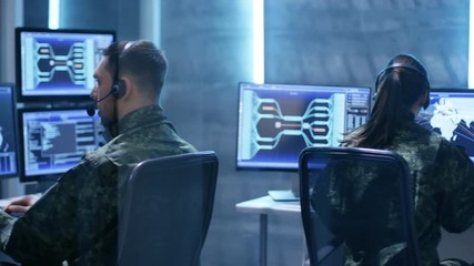 Aufkleber - Female  and Male Military Technical Support Professional Giving Instructions into Headsets. They're in System Control Room with Many Working Screens. Shot on RED EPIC-W 8K Helium Cinema Camera.