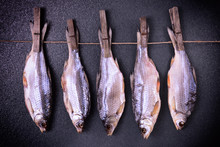 Dried Fish Stew Hanging On Clothespins On A Rope
