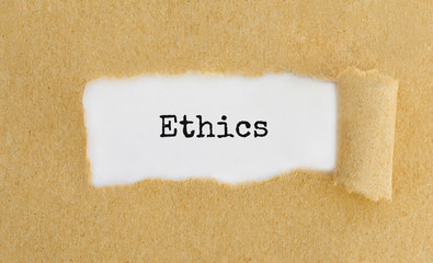 Poster - text ethics appearing behind ripped brown paper.