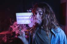 Male Audio Engineer Smoking Electronic Cigarette