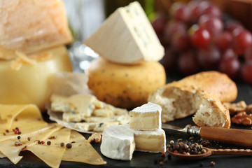 Poster - Slate plate with variety of cheese on table