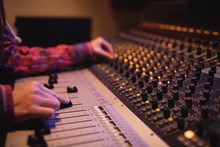 Hands Of Female Audio Engineer Using Sound Mixer