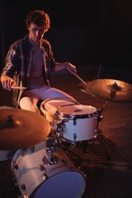 Drummer Playing On Drum Set