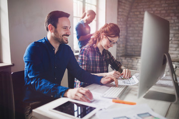 Coworking and corporate colleagues working in office