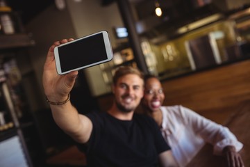 Wall Mural - Happy couple taking selfie from mobile phone