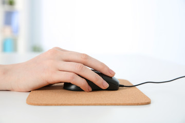 Wall Mural - Hand of woman working with computer mouse in office