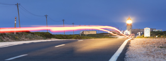 Wall Mural - cars trails on the road to lighthouse