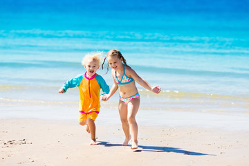 Wall Mural - Kids run and play on tropical beach