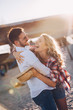 © NDABCREATIVITY - Beautiful couple hugging and dating on beach