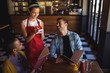© wavebreak3 - Waitress taking order at restaurant
