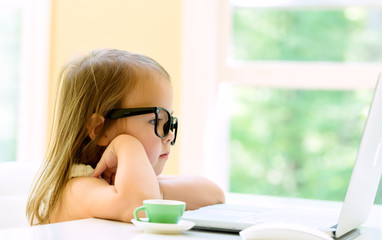 Wall Mural - Little girl with her laptop computer