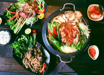 Wall Mural - Prepared hot pot of beef with chili, mushroom, herbs, lemongrass and rice on the table